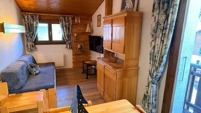 a living room with a bed and a dining room at Les Dômes - Appartement centre village et superbe vue montagne in Les Contamines-Montjoie