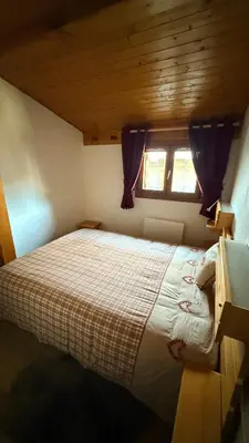 a kitchen with a wooden table and a refrigerator at Les Dômes - Appartement centre village et superbe vue montagne in Les Contamines-Montjoie