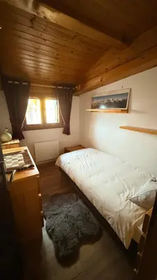 a living room with a bed and a table at Les Dômes - Appartement centre village et superbe vue montagne in Les Contamines-Montjoie