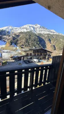 a kitchen with a wooden table in a room at Les Dômes - Appartement centre village et superbe vue montagne in Les Contamines-Montjoie