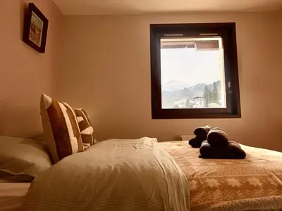 a bedroom with a bed with a teddy bear on it at Le Saphir Montagne & Ski in Saint-Gervais-les-Bains