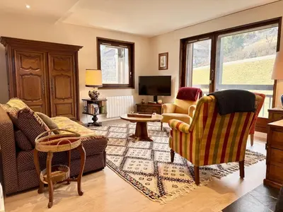 a living room with chairs and a tv at Le Saphir Montagne & Ski in Saint-Gervais-les-Bains
