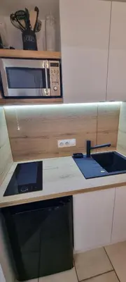 a kitchen counter with a microwave and a sink at Les Arcades N105 ST4 in Morillon