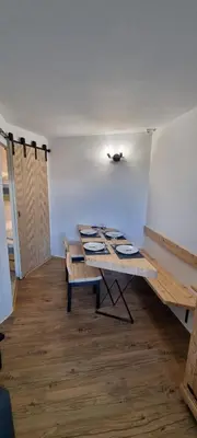 a room with a table and benches in it at Les Arcades N105 ST4 in Morillon