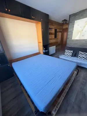 a bedroom with a bed in a room at Studio COCOONING LE CARIBOU in Les Carroz d'Araches
