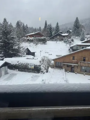 a view of a snow covered yard with buildings at Studio COCOONING LE CARIBOU in Les Carroz d'Araches
