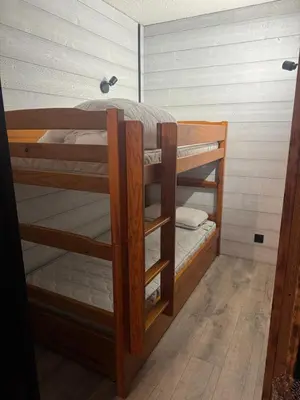 two bunk beds in a small room with at Studio COCOONING LE CARIBOU in Les Carroz d'Araches