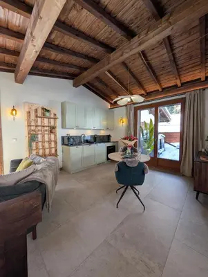 a kitchen and living room with a bed and a table at Stunning New Apartment in Chamonix with Mont Blanc Views in Chamonix-Mont-Blanc
