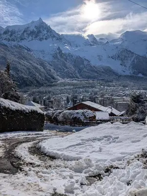 a snow covered road with a mountain in the background at Stunning New Apartment in Chamonix with Mont Blanc Views in Chamonix-Mont-Blanc