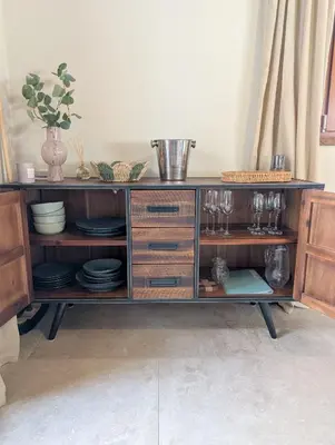 a wooden cabinet with plates and glasses on it at Stunning New Apartment in Chamonix with Mont Blanc Views in Chamonix-Mont-Blanc