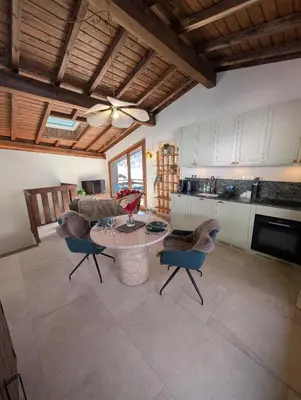 a kitchen with a table and chairs in a room at Stunning New Apartment in Chamonix with Mont Blanc Views in Chamonix-Mont-Blanc