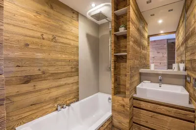 a bathroom with a white tub and a sink at Appartement Thoret - 3 étoiles - Welkeys in Megève