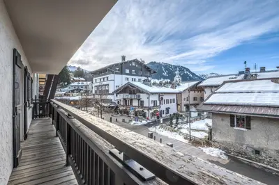 a balcony with a view of a town at Appartement Thoret - 3 étoiles - Welkeys in Megève