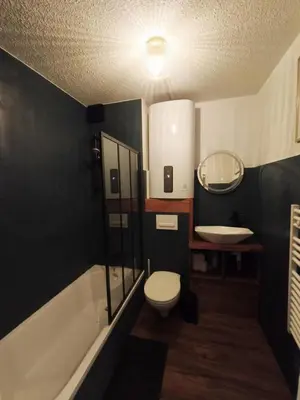 a bathroom with a toilet and a sink and a tub at Gamebox in Carroz in Les Carroz d'Araches