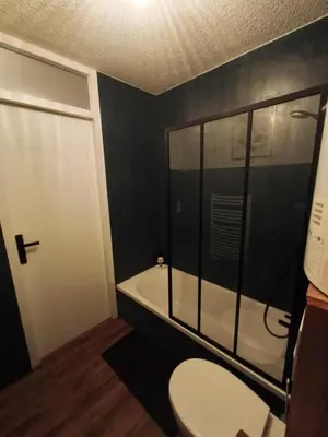 a bathroom with a toilet and a bath tub at Gamebox in Carroz in Les Carroz d'Araches