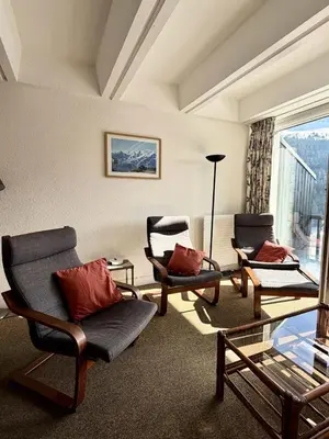 a living room with a couch and a table and chairs at Résidence Aldebaran - Appartement spacieux · Départ et retour ski aux pieds · Balcon · Casier à ski · WIFI gratuit MAE-1963 in Magland