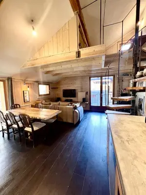 a large living room with a table and a couch at Le Refuge in Chamonix-Mont-Blanc