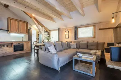 a living room with a couch and a table at Le Refuge in Chamonix-Mont-Blanc