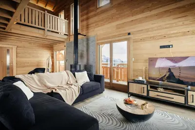 a living room with a couch and a flat screen tv at Chalet Alpage du Bettex - OVO Network in Mémontel