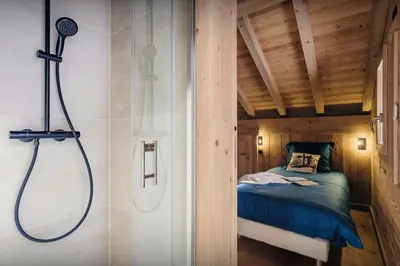 a bathroom with a shower and a bed in a room at Chalet Alpage du Bettex - OVO Network in Mémontel