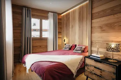 a bedroom with a red bed and a window at Chalet Alpage du Bettex - OVO Network in Mémontel