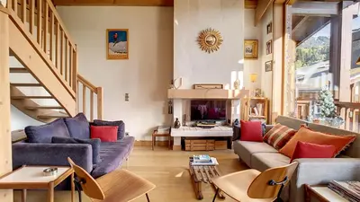 a living room with two couches and a fireplace at 1 Sporting Acacia 2 - JAILLET - in Megève