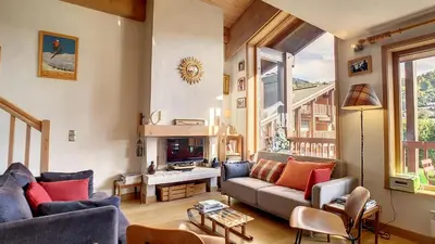 a living room with a couch and a fireplace at 1 Sporting Acacia 2 - JAILLET - in Megève