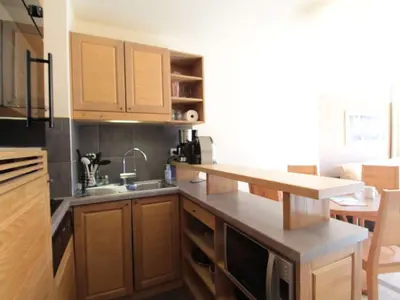 a kitchen with wooden cabinets and a counter top at Appartement 2 Pièces Pied des Pistes avec Wi-Fi et Parking - FR-1-687-120 in Arâches-la-Frasse