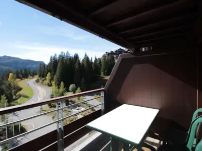 a balcony with a table and a view of a road at Appartement 2 Pièces Pied des Pistes avec Wi-Fi et Parking - FR-1-687-120 in Arâches-la-Frasse