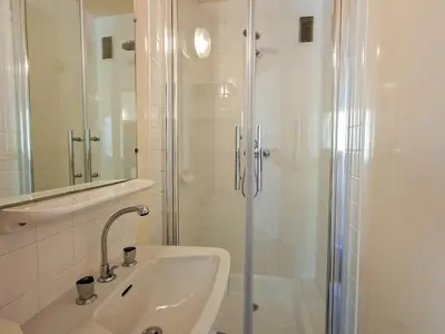 a white bathroom with a shower and a sink at Appartement spacieux, ski aux pieds, balcon, 3 pièces, 6-8 personnes - FR-1-425-238 in Arâches-la-Frasse