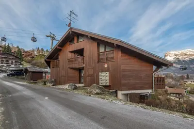 a wooden building on the side of a road at Appartement Le Nid des Sommets - Welkeys in Saint-Gervais-les-Bains