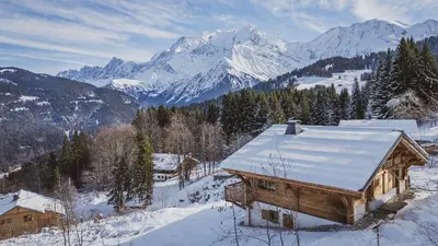 a cabin in the snow with mountains in the background at Chalet de l'Emey - 12 pers in Mémontel
