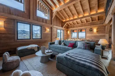 a living room with a couch and a table at Chalet de l'Emey - 12 pers in Mémontel