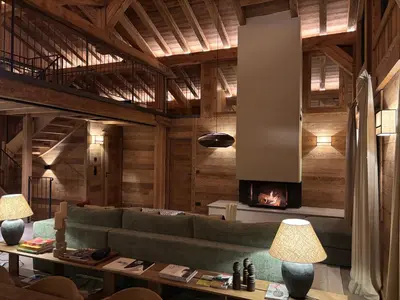 a living room with a couch and a fireplace at Chalet de l'Emey - 12 pers in Mémontel