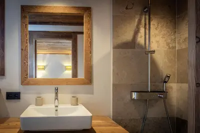 a bathroom with a white sink and a mirror at Chalet de l'Emey - 12 pers in Mémontel
