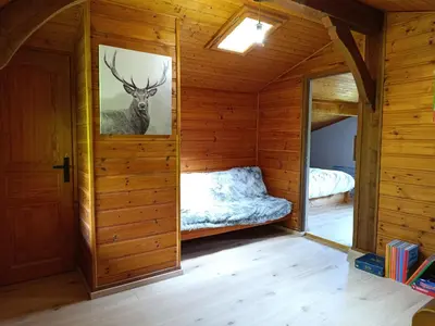 a room with a bed and a picture of a deer on the wall at Le Cairn in Saint-Gervais-les-Bains