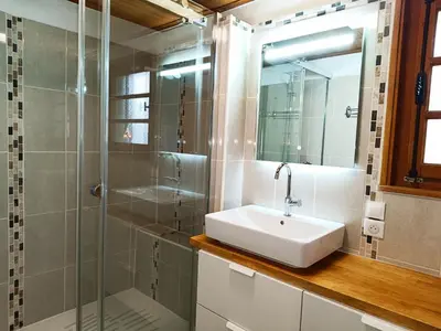 a bathroom with a sink and a shower at Le Cairn in Saint-Gervais-les-Bains