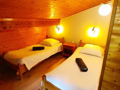 a bedroom with two beds in a wooden cabin at Le Cairn in Saint-Gervais-les-Bains