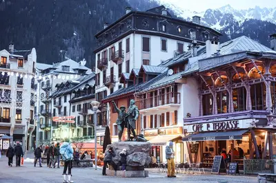 a city with a statue in the middle of a street at Appart Hyper Centre Chamonix balcon parking privé in Chamonix-Mont-Blanc