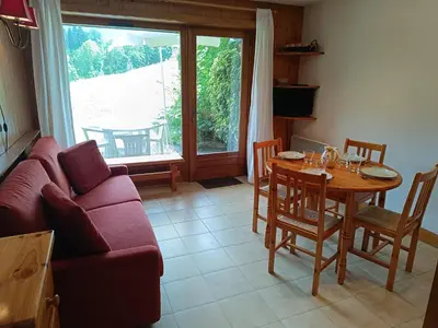 a living room with a couch and a table at Les hautes Cimes in Saint-Gervais-les-Bains