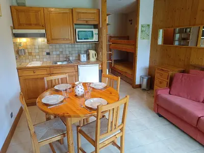 a kitchen and dining room with a wooden table and chairs at Les hautes Cimes in Saint-Gervais-les-Bains