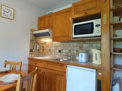 a kitchen with a sink and a microwave at Les hautes Cimes in Saint-Gervais-les-Bains