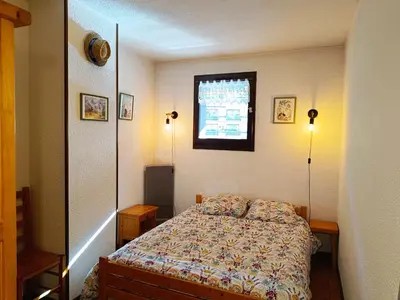 a small kitchen with white cabinets and a white refrigerator at La Comtesse in Saint-Gervais-les-Bains