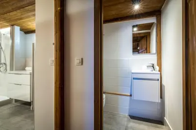 a small bathroom with a sink and a mirror at Rosaline Ferme 220m2 Charme Cheminee Jacuzzi Sauna in Les Houches