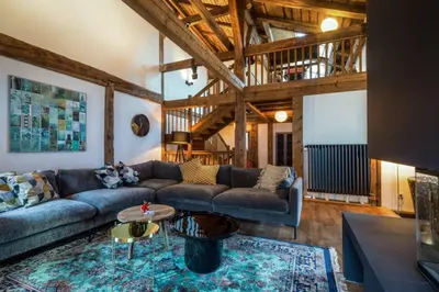 a living room with a couch and a table at Rosaline Ferme 220m2 Charme Cheminee Jacuzzi Sauna in Les Houches