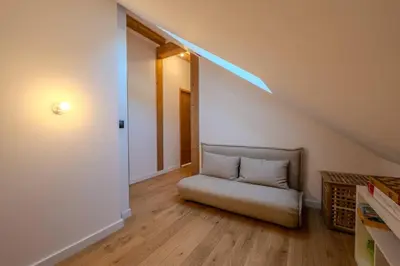 a room with a couch with a light on the ceiling at Canopée Duplex 4 CH Proche Remontees Central Vues in Saint-Gervais-les-Bains
