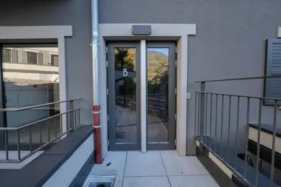 an entrance to a building with a glass door at Canopée Duplex 4 CH Proche Remontees Central Vues in Saint-Gervais-les-Bains
