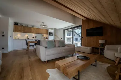 a living room with a couch and a table at Canopée Duplex 4 CH Proche Remontees Central Vues in Saint-Gervais-les-Bains