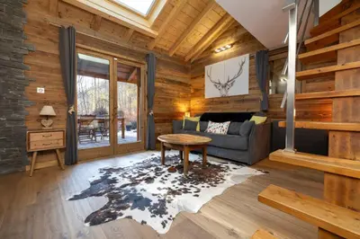 a living room with a couch and a table at Momi Cocon 4pax Jardin Jacuzzi Vue in Chamonix-Mont-Blanc