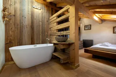 a bathroom with a white bath tub in a room at Momi Cocon 4pax Jardin Jacuzzi Vue in Chamonix-Mont-Blanc